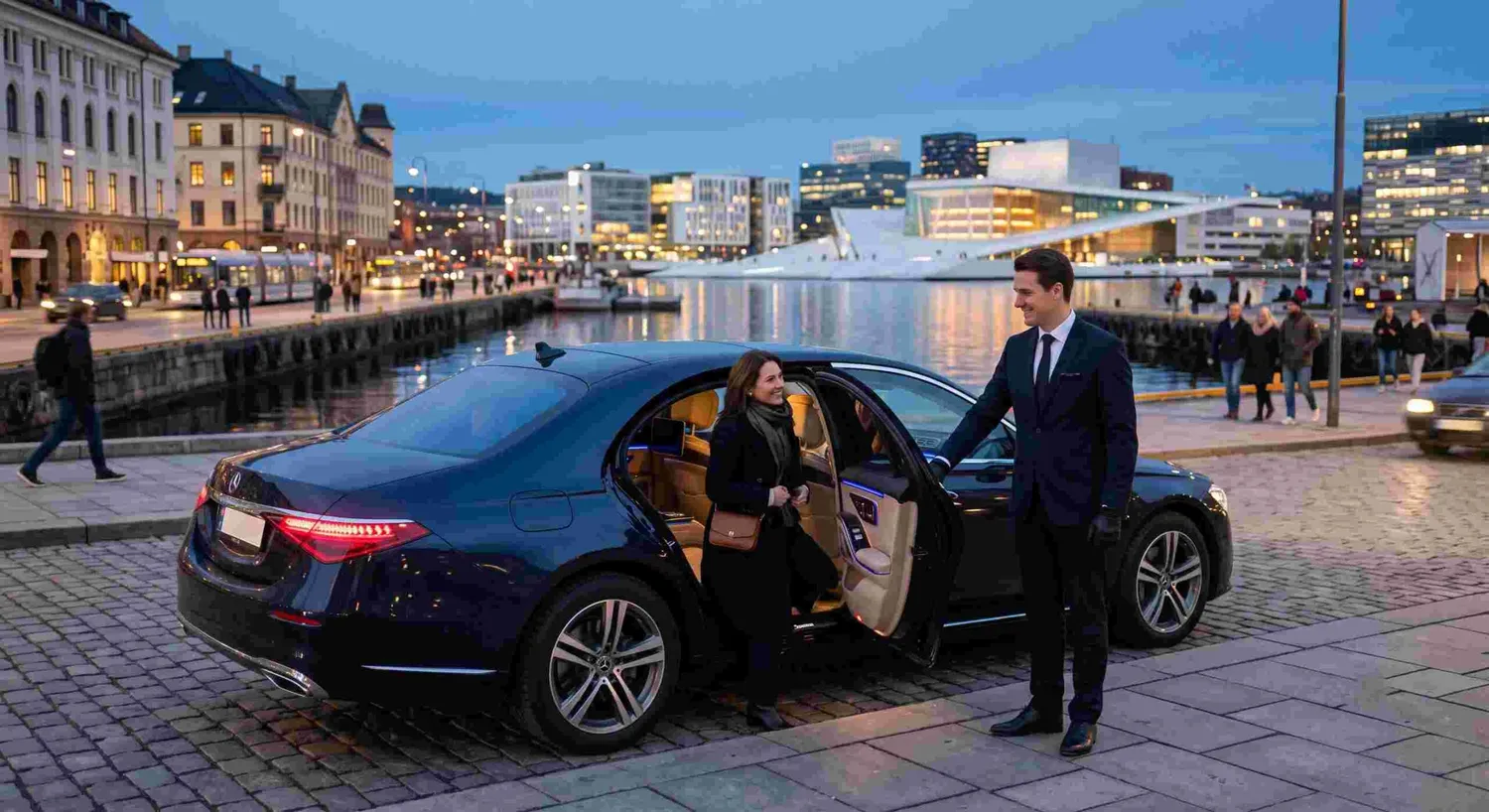 Chauffeur opening the door of a luxury car on the Oslo harbourfront