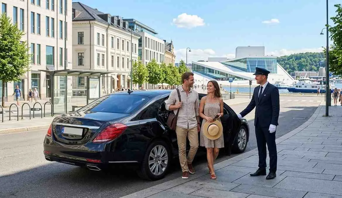 Chauffeur welcoming travellers to a Mercedes on the Oslo waterfront
